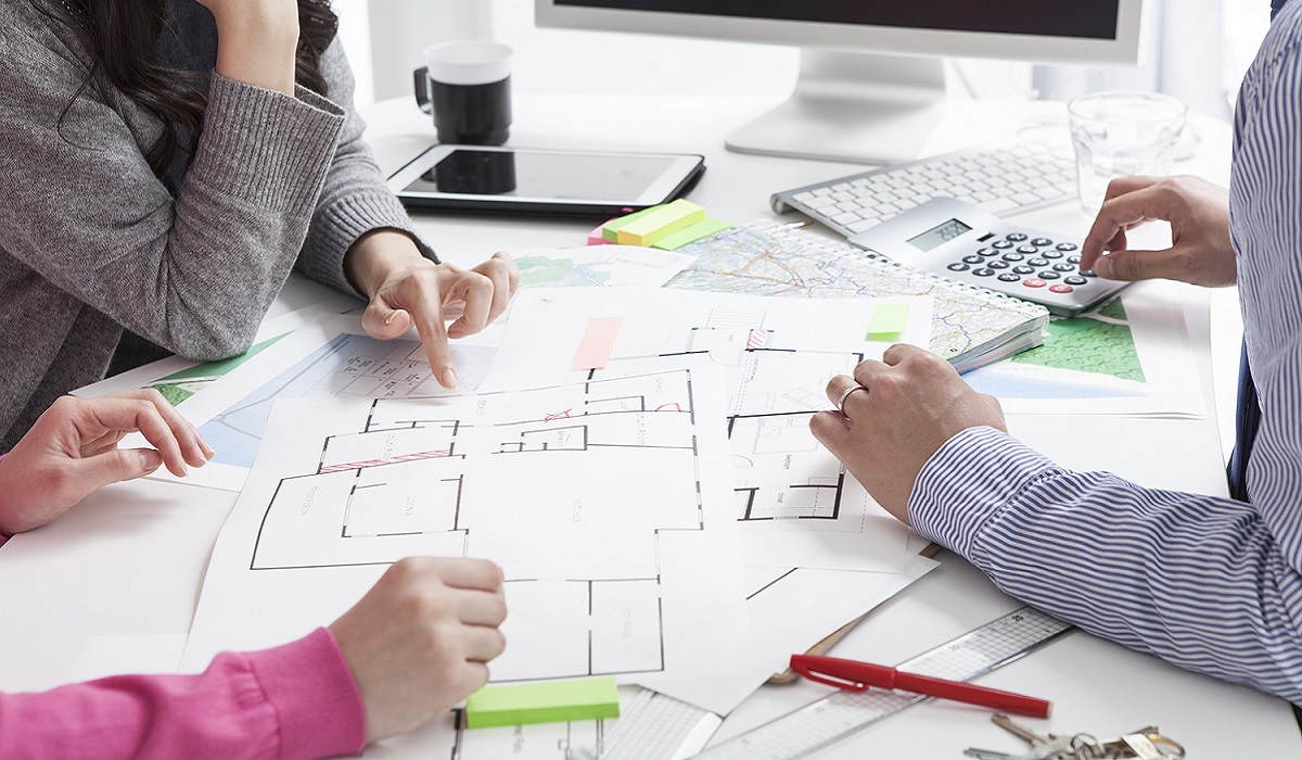 Real-estate agent showing house plans; Shutterstock ID 268567355; Purchase Order: -